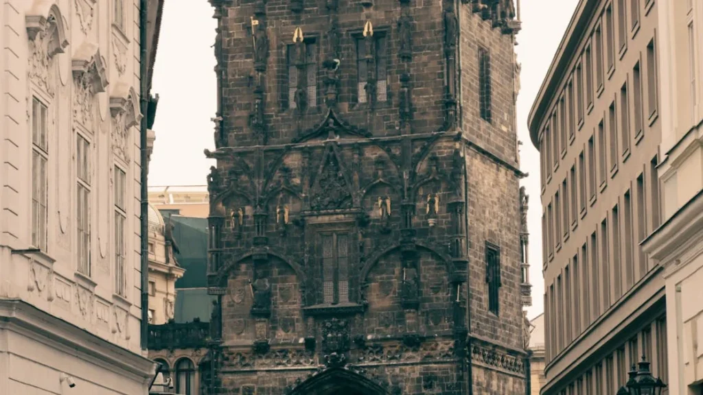 Gothic Powder Tower in Prague rising above surrounding historic buildings at the edge of the Old Town